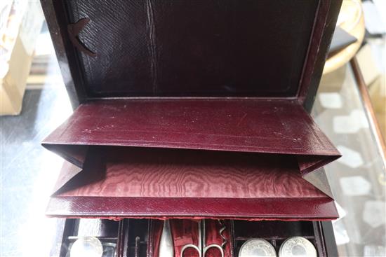 A Victorian brass mounted rosewood toilet box, containing four silver mounted bottles and four nail implements, box 28cm.